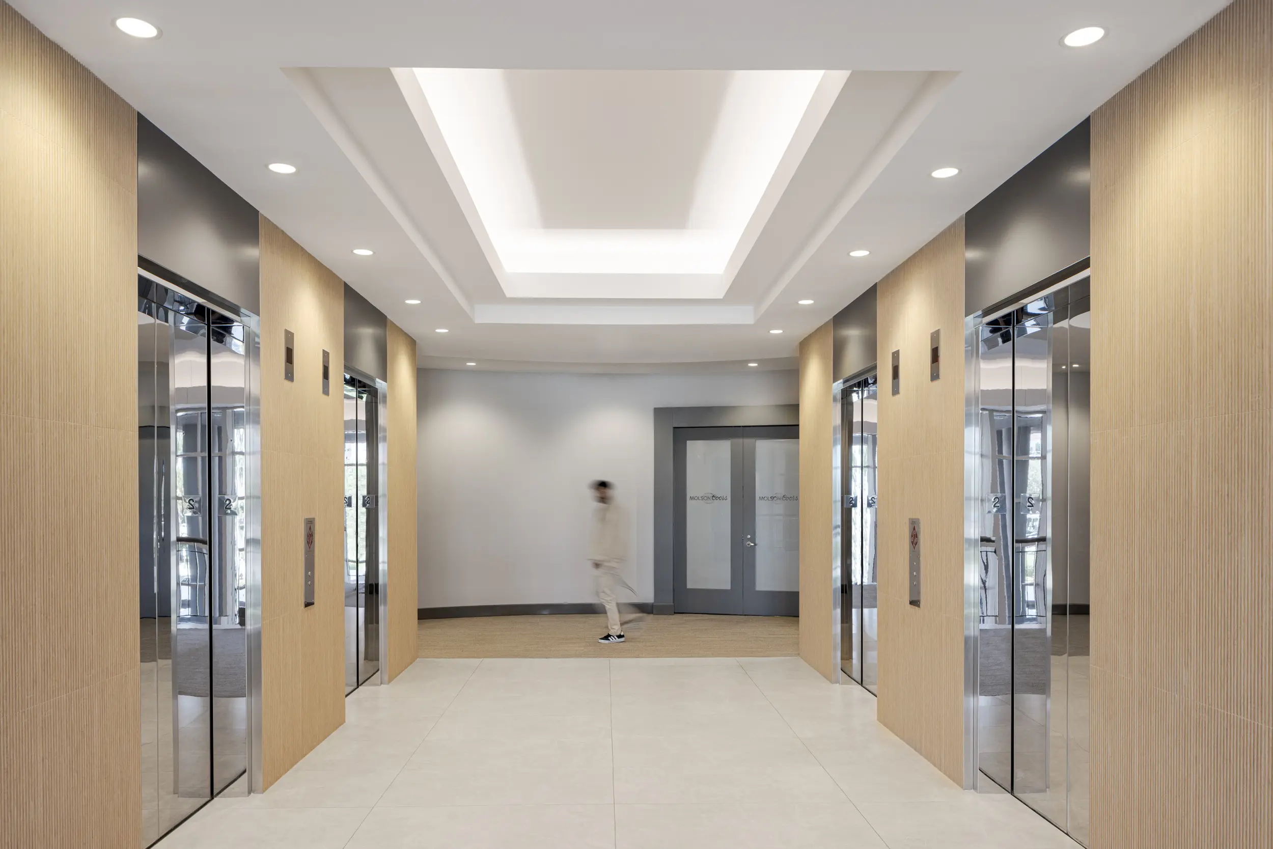 Elevator hallway at Waterford 5200 with recessed lighting, symmetrical layout, and sophisticated wall finishes.webp